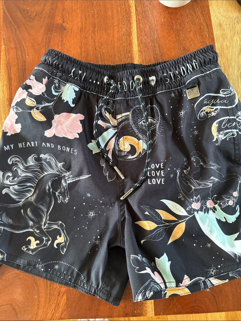 Agua Bendita Kids Black Swim Trunks with Pastel Floral and Unicorn Print